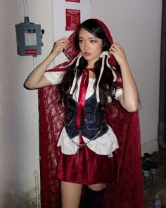 a woman dressed in red and white posing for the camera