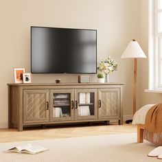 a flat screen tv sitting on top of a wooden entertainment center in a living room