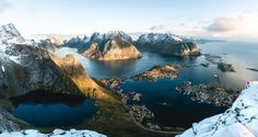 an aerial view of snow covered mountains and lakes