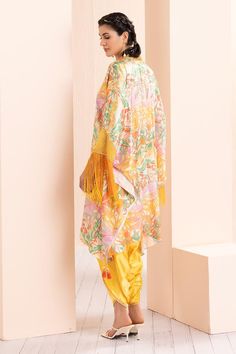 Yellow leafy ash tunic with abstract print and thread and mirror embroidered neckline. Comes with dhoti pant.
Components: 2
Pattern: Printed, Embroidered
Type Of Work: Abstract, Thread, Mirror
Neckline: V Neck
Sleeve Type: Flared Sleeves
Fabric: Satin, Organza
Color: Yellow
Other Details: 
Tasseled detailing on kurta
Occasion: Sangeet - Aza Fashions Summer Silk Sets With Sheer Dupatta, Summer Sets With Sheer Dupatta And Traditional Drape, Traditional Drape Sets With Dupatta For Summer, Summer Sets With Traditional Drape And Dupatta, Bohemian Salwar Kameez With Sheer Dupatta For Summer, Silk Bollywood Style Palazzo Set For Summer, Bollywood Style Silk Palazzo Set For Summer, Bollywood Style Summer Pant Set With Dupatta, Bollywood Style Pant Set With Dupatta For Summer