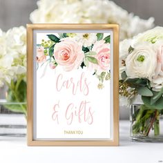 a sign that says cards and gifts on it next to some vases with flowers