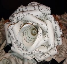 a white rose made out of old book pages