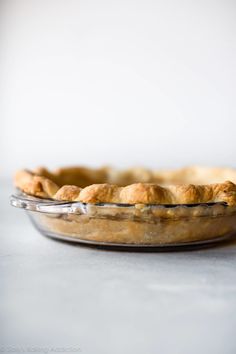 a pie sitting in a glass dish on top of a table