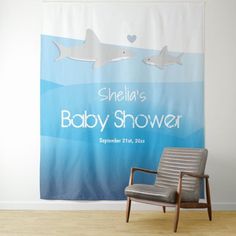 a baby shower curtain with two sharks on it and a chair in front of it