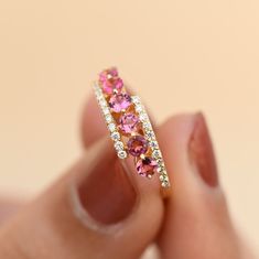 Material: 14k/18k goldColor Options: Yellow Gold, White Gold, Rose Gold★ Center StoneNatural Round Pink TourmalineSize: 3 mm * 7 Nos.Approx Weight (Ct): .84★ Accent StonesNatural Diamond RoundSize: 1.2 mm * 27 Nos.Approx Weight (Ct): 0.19★ Ring Height: 6.0 mm★ Band Width: 1.4 mm 14k Gold Opal Ring, Pink Sapphire Diamond Ring, Pink Sapphire Jewelry, 14k Gold Wedding Ring, Pink Tourmaline Ring, Opal Ring Gold, Tourmaline Jewelry, Natural Gemstone Jewelry, Tourmaline Ring