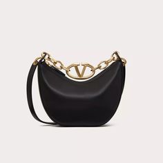 Expertly crafted by Valentino Garavani, the VLogo Moon Mini Bag is a versatile and stylish nappa leather bag. The iconic VLogo Signature chain adds a touch of glamour, while the detachable shoulder strap allows for both crossbody and handbag wear. Elevate any outfit with this luxurious and functional accessory. Leather Bag With Chain Strap For Fashion, Designer Shoulder Bag With Chain Detail, Designer Shoulder Bag With Chain, Luxury Shoulder Bag With Chain In Crossbody Style, Luxury Chain Crossbody Shoulder Bag, Luxury Chain Shoulder Bag Crossbody, Designer Top Handle Bag With Chain, Luxury Chain Shoulder Crossbody Bag, Designer Leather Bag With Chain