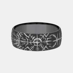 Embark on a journey of commitment with the Viking, a robust men’s wedding band inspired by the spirit of adventure and the lore of the Norse. This 8mm comfort fit ring is forged from darkened tantalum, a material prized for its durability and distinctive appearance. At its heart lies the Viking compass pattern, a symbol steeped in history and mysticism, guiding the wearer through life's voyages. The pattern not only adds a touch of ancient wisdom to the band but also serves as a reminder of the Compass Pattern, Spirit Design, Rugged Look, Ancient Wisdom, Mens Wedding Rings, Mens Wedding Bands, Wedding Men, Compass, Wedding Band