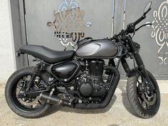 a black motorcycle parked in front of a building