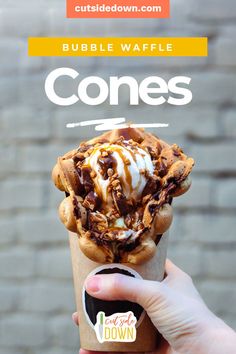 a person holding up an ice cream sundae in front of a brick wall with the words zustatzzegeshafe mit bubble waffle waffles on it