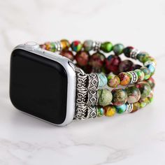 "Colorful Jasper Beaded Apple Watch Strap | Band 38mm 40mm 41mm 42mm 44mm 45mm | Compatible with all Apple Watch Series You will receive: ⭐️1 x Colorful Jasper Beaded Apple Watch Strap ⭐️Returns: Money back guarantee (30 days free returns) ⭐️About Shipping: Your order will be shipped via international Post and it usually takes 7-14 days to arrive iWatch strap is fully customizable  and is perfect for small wrists and big wrists!  🔹 Please message me for customized sizing 🔹 Rainbow jasper is called a \"sustaining stone,\" and thought to be helpful in times of emotional fatigue or stress. Used for its properties to both calm and sooth, it is believed to be beneficial in collecting one's thoughts so as to help one feel more secure and relaxed when making decisions. NenjuBand has become a ch Multicolor Rectangular Apple Watch Band With Bracelet Strap, Casual Multicolor Apple Watch Band As Gift, Adjustable Multicolor Apple Watch Band With Round Beads, Casual Apple Watch Band Bracelet Strap As Gift, Casual Apple Watch Band Bracelet For Gift, Casual Apple Watch Band With Bracelet Strap As Gift, Bohemian Watch Bands With Bracelet Strap, Casual Multicolor Watch Bands As Gift, Beaded Apple Watch Band Gift