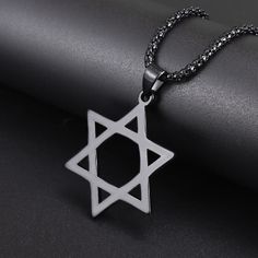 Star of David Stainless Steel Necklace in Black - Mounteen Symbolic Black Stainless Steel Necklace, Symbolic Black Star Of David Jewelry, Symbolic Black Pendant Necklace, Black Star Of David Necklace, Spiritual Style, Black Star Of David Spiritual Necklace, Black Spiritual Necklace With Star Of David, Black Spiritual Star-shaped Jewelry, Black Star-shaped Spiritual Jewelry, Wolf Tooth Necklace