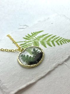 Real Fern Handmade Terrarium Necklace, Woodland Plant Preserved Jewelry, Miniature Dainty Necklace, Cottagecore Necklace A simple pendant on a gold chain featuring real ferns and soil encased in resin. This is a dainty and classic piece designed for a nature lover. It looks like a tiny terrarium that you can wear at all times as it goes with anything. This is a perfect gift for your mom, friend, sister or aunt who loves nature and cottagecore vibes. More information on my Instagram here: River G Tiny Terrarium, Cottagecore Necklace, Cottagecore Vibes, Woodland Plants, Terrarium Necklace, Simple Pendant, Necklace Resin, Mom Friend, Gifts For Your Mom