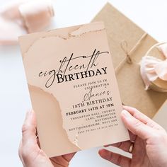 a woman holding up a birthday card in her hands