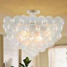 a living room filled with furniture and a large chandelier hanging from the ceiling