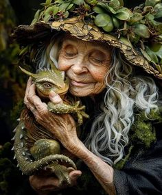 an old woman with long white hair and a hat holding a lizard in her hands