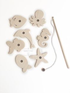 wooden cutouts of sea animals and a knitting needle