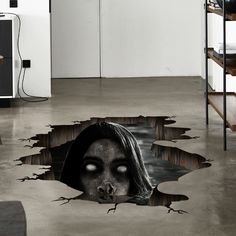 a hole in the floor with a woman's face on it