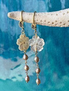 Beautiful carved mother of pearl flower on gold vermeil earrings with a labradorite tear drop gemstone and champagne fresh water pearls.  High quality gold vermeil earrings.  The earrings measure approximately 2 3/4" long.  Flower is approximately 1".  Freshwater pearl dangle measures 1.5". Simple and elegant chic look! Beautiful bridesmaid gift, perfect for a beach wedding! Ships ready for gifting in wrapped in a gauze bag. Elegant Mother Of Pearl Flower Shaped Jewelry, Elegant Mother Of Pearl Flower-shaped Earrings, Elegant Mother Of Pearl Flower Earrings For Weddings, Fine Jewelry Briolette Pearl Charm, Elegant Mother Of Pearl Flower Earrings, Mother Of Pearl Flower Jewelry For Anniversary, Anniversary Jewelry Mother Of Pearl Flower Shape, Anniversary Jewelry In Flower Shape With Mother Of Pearl, Delicate Mother Of Pearl Jewelry For Wedding