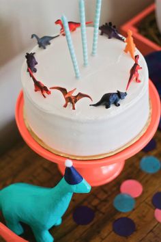 a birthday cake with dinosaur decorations on it