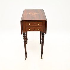 a small wooden table with two drawers on one side and an open drawer on the other