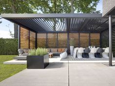 an outdoor living area with couches and pillows