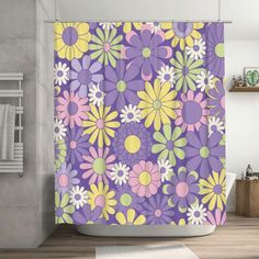 a bathroom with a purple shower curtain that has colorful flowers on it and yellow circles around the edges