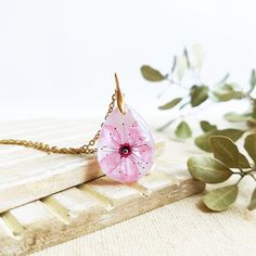 This Cherry blossom necklace is part of my cherry blossom jewelry collection. The sakura flower is highly admired in Japan, so take this sakura flower necklace with you to wear a little piece of this magic beauty. This real flower necklace will never make you go unnoticed because it is really elegant and unique. A cherry blossom necklace to have the Spring always with you... The chain is made of hypoallergenic stainless steel. The resin provides this cherry blossom necklace a perfect crystalline Rose Gold Flower Pendant Necklace Nature-inspired, Rose Gold Flower Pendant Necklace, Nature-inspired, Pink Flower-shaped Necklaces For Mother's Day, Rose Gold Nature-inspired Flower Pendant Necklace, Delicate Pink Pendant Flower Necklace, Delicate Pink Flower Pendant Necklace, Handmade Pink Flower-shaped Necklace, Delicate Pink Flower Necklace For Gift, Delicate Pink Flower-shaped Necklace