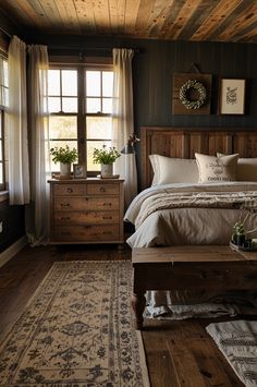 a bedroom with wooden walls and flooring has a bed, dressers, and window