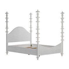 a white bed with four posts on the headboard