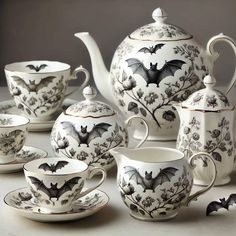 a tea set with bats painted on it