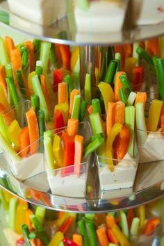 several trays filled with assorted veggies on top of each other