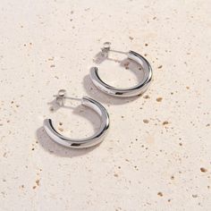 Stock your jewelry box with our new, better-than-basic Bijou Cali Silver Hoops. These lovely silver hoop earrings are slightly smaller than our classic Cali Silver Hoops. They’ll look amazing with your favorite silver jewellery pieces. Perfectly weighted and designed with simple and clean lines, these dainty hoops are an essential day-to-night accessory. We love wearing the Bijou Cali Hoops with a lace blouse and tailored slacks for daytime events, or pairing them with a flirty going-out dress a Minimalist Metal Hoop Earrings With Polished Finish, Everyday Silver Metal Huggie Earrings, Silver Minimalist Hoop Earrings With Polished Finish, Minimalist Silver Hoop Earrings With Polished Finish, Everyday White Gold Metal Hoop Earrings, Classic Silver Huggie Earrings For Everyday, Modern Silver Huggie Earrings With Shiny Finish, Minimalist Polished Silver Huggie Earrings, Minimalist Silver Huggie Earrings With Polished Finish