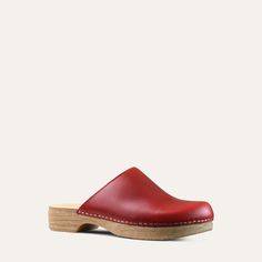 The Helena classic clog is one of our all-time favorites. It has the look of a traditional clog but on a flat base. Red leather. With its cushioned, flexible sole, the Helena clog is both stylish and easy to wear. Designed in Sweden and handmade in Italy. Heel: 3cm / 1.18" Inches Soft Padded footbed Flexible base with wood-like effect Classic Slip-on Clogs With Leather Sole, Classic Mules With Rubber Sole And Round Toe, Classic Flat Clogs With Rubber Sole, Classic Slip-on Clogs With Rubber Sole, Comfortable Flat Clogs With Rubber Sole, Slip-on Clogs With Rubber Sole And Plain Toe, Classic Slip-on Clogs With Plain Toe, Classic Leather Sole Slip-on Clogs, Leather Sole Slip-on Clogs With Plain Toe