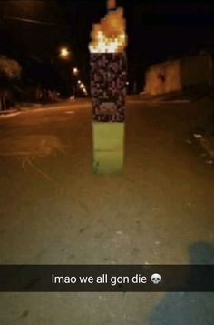 a fire hydrant sitting on the side of a road at night with words written below it