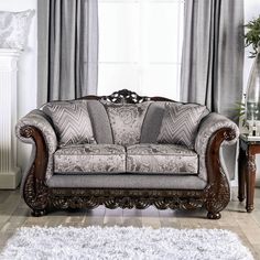 a living room filled with furniture next to a white rug and window covered in curtains