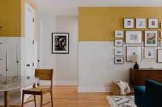 a living room filled with furniture and pictures on the wall