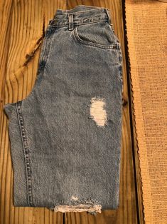 High waisted with distress detail. Lee jeans from the 90s. 90s Style Distressed Bottoms For Fall, 90s Distressed Bottoms For Fall, 90s Style Distressed Dark Wash Jeans, 90s Distressed Straight Leg Bottoms, 90s Distressed Mid-rise Bottoms, 90s Style Distressed Denim Blue Jeans, Acid Wash Ripped High Rise Jeans, 90s Distressed Dark Wash Jeans, 90s Distressed Denim Blue Jeans