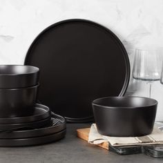 black dishes and glasses are sitting on the counter