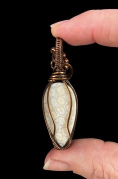 Fossilized coral cabochon wrapped in copper wire that has been oxidized and polished. The pendant comes in a jewelry gift box with a black waxed cord and small polishing pad. Size: 53 x 17 x 13 mm. 6 grams. Fossilized Coral, Mineral Jewelry, Phantom Quartz, Sterling Silver Wire Wrap, Diamond Quartz, Calcite Crystal, Argentium Silver, Wrapped Pendant, Wire Wrapped Pendant