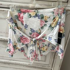 Cute White Floral Shorts From Forever 21 Size Large Has A Zipper On The Back And A Bow/Knot Detail On Front Spring High-waisted Shorts For Brunch, White Shorts For Brunch In Spring, Spring Brunch High-waisted Shorts, Summer Bottoms With Tie Waist For Brunch, Summer Style Bottoms With Tie Waist For Brunch, Forever 21 Beach Shorts For Spring, White Floral Print Shorts For Beach Season, White Floral Print Bottoms For Brunch, White Summer Shorts For Brunch