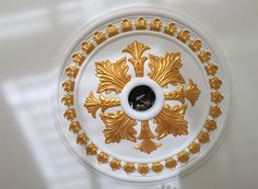 a white and gold plate with an ornate design