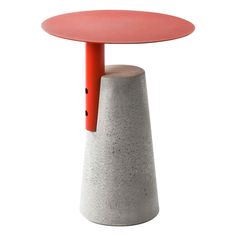 a small table with a red top and two legs on one side, sitting in front of a white background