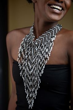 Unique African Maasai Handcrafted Beaded Necklace with an Elegant Look and Brilliant Finish. Color = White, Black and Silver. Length (Around Neck) = Adjustable Width. Length ( Downwards ) = 11 Inches / 28 cm. **GET FREE SHIPPING FOR ADDITIONAL ITEMS PURCHASED. Yes, Buy Multiple Items and pay shipping for 1 item only- The rest ships Free. (No Limits on the number of Multiple items). With a faster delivery time of 3 days via DHLExpress, Worldwide. Ordinary/Standard Shipping also available upon req Bohemian White Jewelry With Black Beads, Traditional Beaded Bib Necklace For Party, White Bohemian Necklace With Black Beads, Bohemian Bib Necklaces For Jewelry Making With Black Beads, Artisan Beaded Necklace With Black Beads, Artisan Beaded Bib Necklace, Artisan Beaded Necklace With Dangling Beads, Bohemian Silver Bib Necklace With Beaded Chain, Festival Silver Beaded Bib Necklaces