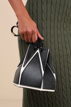 Elevate your accessories game instantly with the Lulus Unparalleled Style Black and White Color Block Bucket Bag! Smooth vegan leather, in contrasting hues of black and white in a geometric-style design, shapes this structured bucket bag with a flat bottom silhouette and a unique drawstring top that cinches with slender, twin tote handles. A slender, detachable shoulder strap allows for various styling options, while the roomy interior keeps all your must-have essentials safe and sound! Gold har Chic Geometric Leather Bag, Black Geometric Bag For Everyday Use, Modern Black Geometric Bags, White Geometric Bag For Everyday Use, Black Structured Bag With Adjustable Strap, Structured Black Bag With Adjustable Strap, Trendy Black Geometric Bag, White Geometric Everyday Bag, Everyday Geometric White Bag