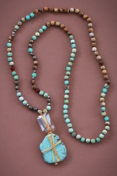 Style: Boho, Eclectic Main Feature: Turquoise Stone Wire-Wrapped Pendant Bead Type: Mixed Stone Beads Length: Approximately 34 inches Pendant Dimensions: 1.4 x 3 inches Color Variability: Each piece is unique; color patterns may vary Key Attributes: Healing Crystal Necklace: Incorporates stones reputed for their healing properties Statement Necklace: Designed to stand out Chunky Necklace: Features substantial, eye-catching stones Protection Necklace: Made with stones believed to offer protection Long Necklace: Ideal for layering or wearing solo Multi Gemstone Necklace: Includes various semi-precious stones Natural Semi-Precious Stone Necklace: Crafted from genuine natural stones Real Stone Necklace: Ensures authenticity and quality Bead Necklace: Beautifully strung with mixed stones Large Turquoise Lariat Beaded Necklace With Colorful Beads, Turquoise Hand Wrapped Jewelry For Festivals, Hand Wrapped Turquoise Jewelry For Festivals, Turquoise Lariat Beaded Necklace For Festival, Turquoise Hand Wrapped Necklaces For Beach, Turquoise Hand Wrapped Necklace For Beach, Turquoise Hand Wrapped Beach Necklace, Adjustable Turquoise Jewelry With 108 Beads, Bohemian Turquoise Crystal Necklaces For Beach