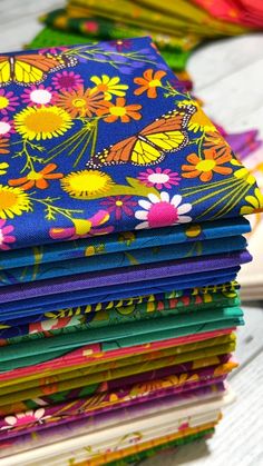 a stack of brightly colored fabric sitting on top of a table