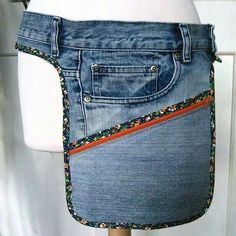 a white mannequin wearing a blue jean skirt with an orange stripe down the side