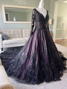 a black and purple dress on display in a living room