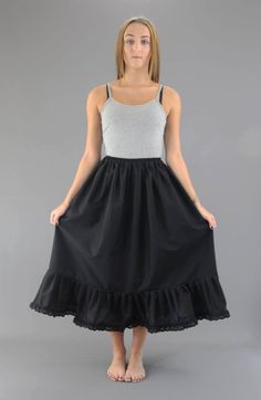 Black Cotton Petticoat (50% cotton, 50% polyester) Gathered Top Section attached onto a separate Cotton covered elasticated waistband Waist made to order - please choose waist size from options Bottom Tier approximately 2.5 times larger than top section all beautifully gathered together This Petticoat can be left with a plain hem, lace hem or broderie anglaise/eyelet hem - you choose - please see options We also make up a lighterweight version of this petticoat which can be found in our shop Finally choose your exact length - see options Once all confirmed we will make up your Petticoat to your exact size Solid Cotton Skirt For Daywear, Cotton Ruffle Skirt For Daywear, Plain Cotton Skirt For Daywear, Cotton Petticoat With Gathered Skirt For Daywear, Cotton Petticoat With Ruffled Tiered Skirt, Cotton Ruffled Tiered Petticoat, Spring Cotton Petticoat With Ruffled Skirt, Daywear Tiered Gathered Petticoat, Cotton Ruffled Petticoat For Spring