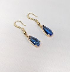 Handmade Wedding Earrings Medium Sapphire Blue Faceted Teardrop All Gold Plated Elements I made these beautiful faceted tear drop earrings using sapphire medium blue cut crystals in a gold plated setting.  All other elements, including the ear wires are gold plated too.  The ear wires also have small CZ stones. The earrings measure 1.75 inches long by 3/8 inches wide. Blue Briolette Earrings For Formal Occasions, Blue Briolette Jewelry For Party, Sapphire Crystal Drop Earrings For Formal Occasions, Elegant Faceted Teardrop Earrings, Sapphire Teardrop Crystal Earrings For Formal Occasions, Sapphire Dangle Crystal Earrings For Formal Occasions, Sapphire Crystal Dangle Earrings For Formal Events, Sapphire Crystal Dangle Earrings For Formal Occasions, Elegant Blue Faceted Crystal Earrings